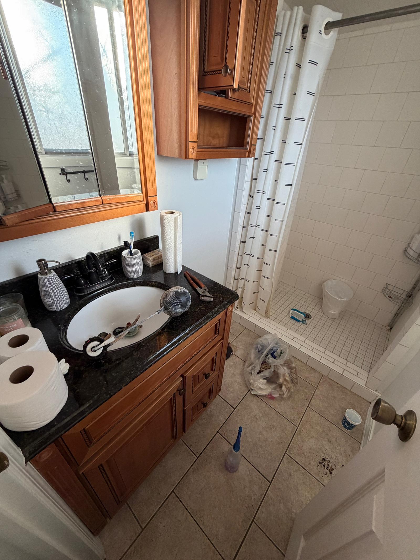 A stuck toilet flapper caused this bathroom to flood and leak into th...